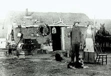 Mr. and Mrs. Curry in front of their sod house.