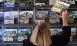 Woman considering homes in an estate agents in Edinburgh. David Cheskin/PA Wire